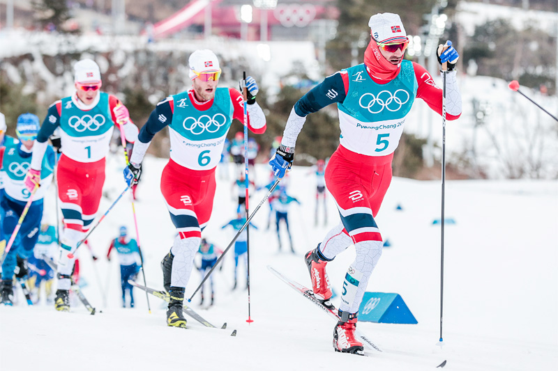 OL-skiathlon i Pyeongchang 2018. Hans Christer Holund fører an foran Martin Johnsrud Sundby og Johannes Høsflot Klæbo. I mål var de to førstnevnte nummer 3 og 2. Foto: Modica/NordicFocus. OL-skiathlon i Pyeongchang 2018. Hans Christer Holund fører an foran Martin Johnsrud Sundby og Johannes Høsflot Klæbo. I mål var de to førstnevnte nummer 3 og 2. Foto: Modica/NordicFocus.