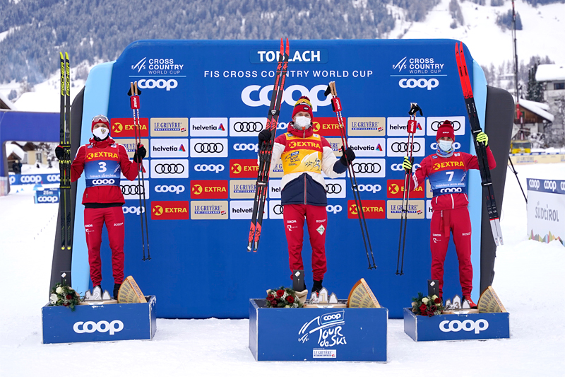 Herrenes seierspall på femte etappe av Tour de Ski 2020/2021. FV: Ivan Yakimushkin (2. plass), Alexander Bolshunov (1) og Evgeniy Belov (3). Foto: Modica/NordicFocus. Herrenes seierspall på femte etappe av Tour de Ski 2020/2021. FV: Ivan Yakimushkin (2. plass), Alexander Bolshunov (1) og Evgeniy Belov (3). Foto: Modica/NordicFocus.