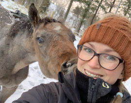 Anne-Rebekka Kulseng-Hansen og en nysgjerrig firbeint hjemme på Sæteråsen stall og rideskole. Foto: privat