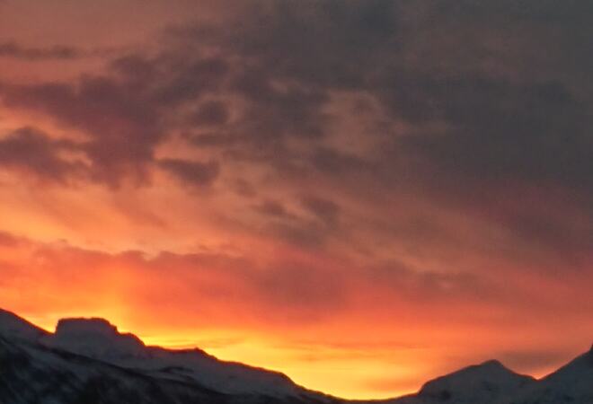 Orange himmel speiler seg i fjorden